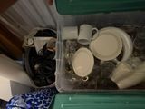 a plastic container filled with cups and other items