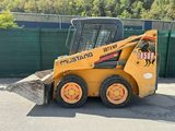 a picture of a yellow ski - loader parked in a parking lot
