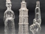 three clear glass vases sitting next to each other on a table