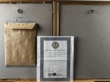 a picture of an old suitcase with a certificate on it