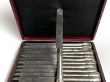 a red case with a set of knives in it