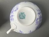 several blue and white tea cups and saucers on a table