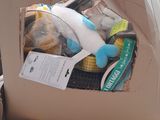 a cardboard box with a stuffed animal inside of it