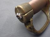 a close up of a gold ring with a diamond on it