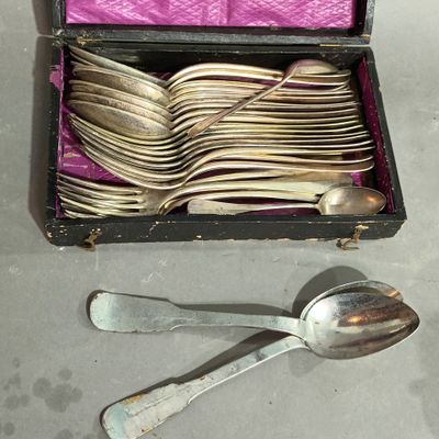 a box of silver spoons and spoons sitting on a table