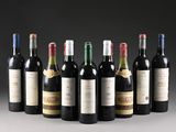 six bottles of wine are lined up in a row on a table