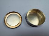 a close up of two tins on a table with a white background