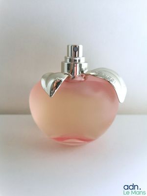 a pink apple shaped perfume bottle with a silver top