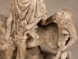 a statue of a man riding a horse with a boy on it