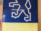 a blue and yellow sign that says peugeot on it