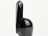 a black sculpture of a bird on a white surface