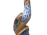 a figurine of a bird sitting on top of a rock