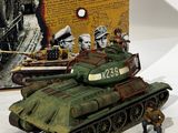 a toy of a tank on a table next to a book