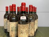 six bottles of wine are lined up on a table