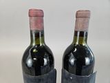 two bottles of wine that are sitting on a table