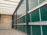 a green and white enclosed area with a wooden floor