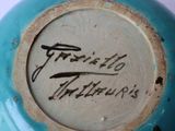 a close up of a blue vase with writing on it