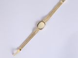 a close up of a watch on a white surface with a white background