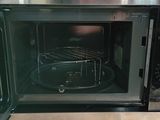 a stainless steel oven with a rack inside of it