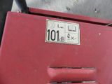 a close up of a red box with a number plate on it