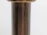 a close up of a metal object on a white surface