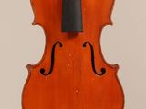 an old violin with a bow hanging from it ' s back