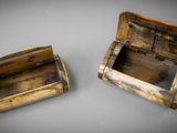 two small wooden boxes sitting on top of a table next to each other