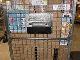 a metal cart with many boxes on it in a warehouse