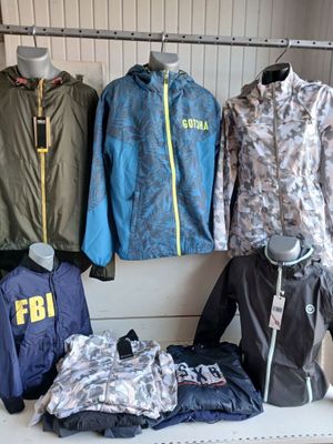 many different jackets and jackets on display in a store