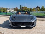 the front view of a black sports car parked on the side of the road