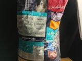 a bag of dog food sitting on a table next to a lamp