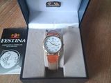 a watch in a box on a table next to a book