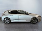 the silver car is parked on the concrete floor in the room