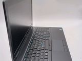 a laptop computer sitting on a table with a keyboard