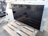a television sitting on top of a pallet next to a chair