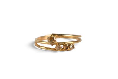 a close up of a gold ring with three stones on it