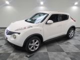 a picture of a white nissan suv parked in a garage