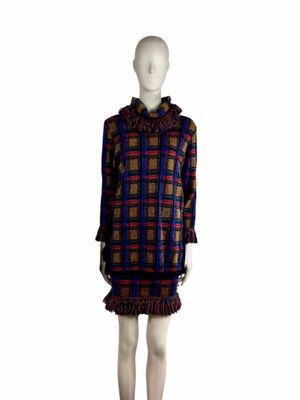 the mannequin is wearing a plaid dress with ruffled hems