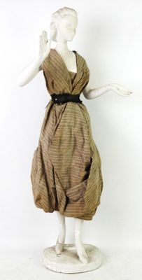a mannequin wearing a brown dress and a black belt