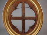 an image of a gold framed mirror with a cross in the middle