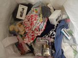 a bag full of items sitting on a bed