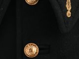 a close up of a black coat with gold buttons