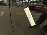 a person taking a picture of a parking ticket