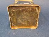 a small metal box that is sitting on a blue surface