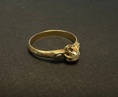 a close up of a gold ring on a black surface