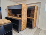 a kitchen with black cabinets and a wooden counter top