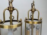pair of antique brass and glass lanterns on a white background