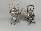 two silver tea kettles and a folding chair on a white background