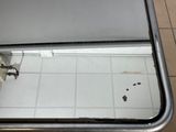 a dirty sink with a mirror on the floor