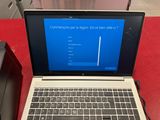a laptop computer sitting on a red table with a blue screen